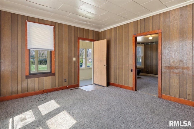 spare room with dark colored carpet and ornamental molding