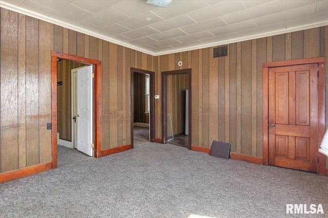 unfurnished bedroom featuring dark carpet and crown molding