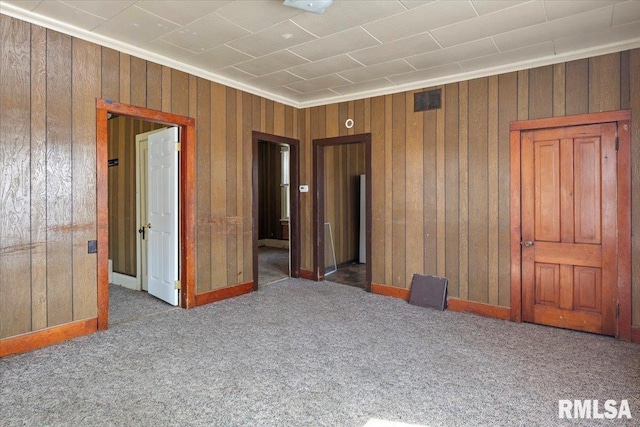 unfurnished bedroom featuring carpet flooring and crown molding