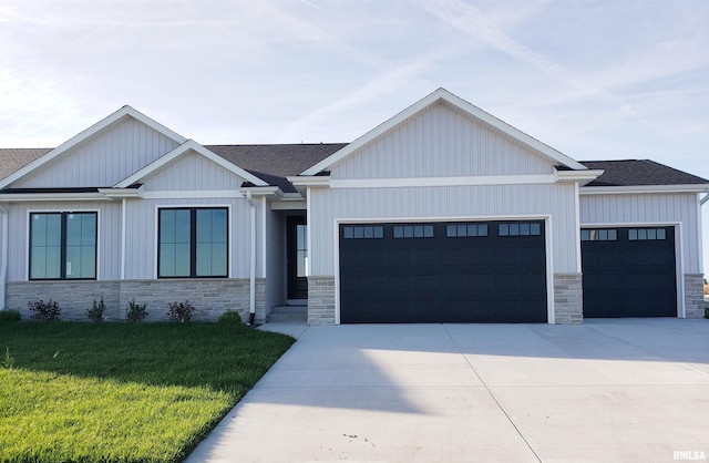 view of front of home with a garage and a front lawn