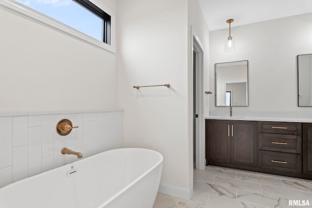 bathroom featuring a washtub and vanity