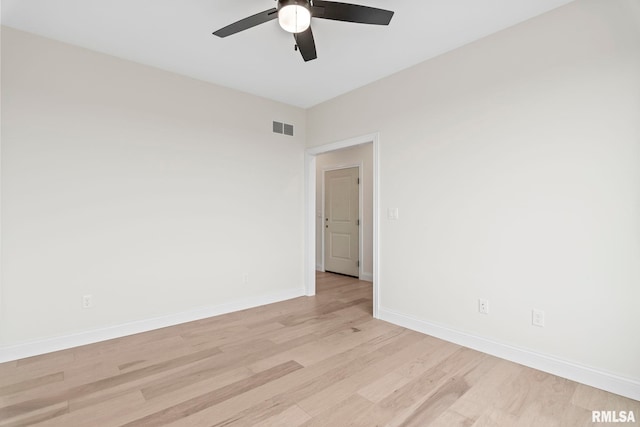 empty room with ceiling fan and light hardwood / wood-style flooring