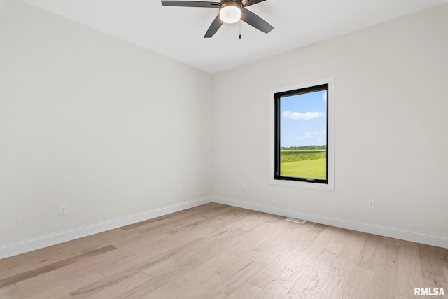 spare room with light hardwood / wood-style floors and ceiling fan