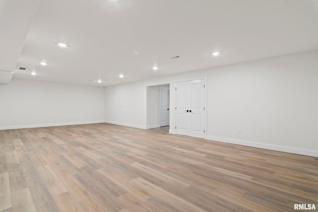 spare room with light hardwood / wood-style flooring