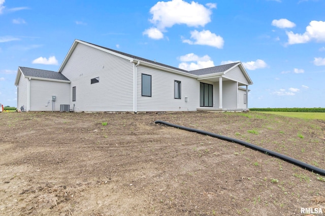 rear view of property featuring central AC unit