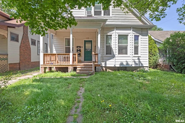 view of front of property with a porch and a front yard