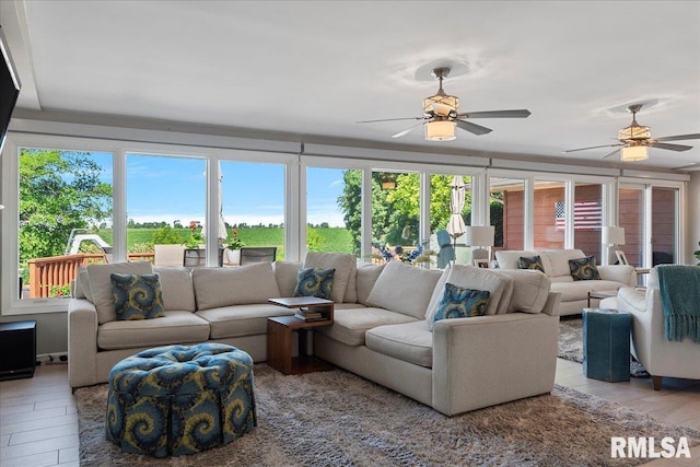 living room featuring light wood-type flooring and ceiling fan