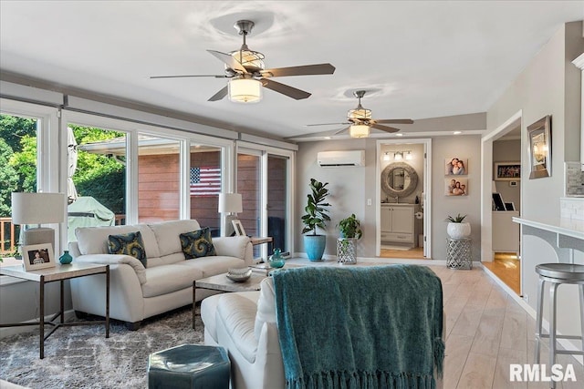 living room featuring ceiling fan, light hardwood / wood-style flooring, and a wall mounted AC