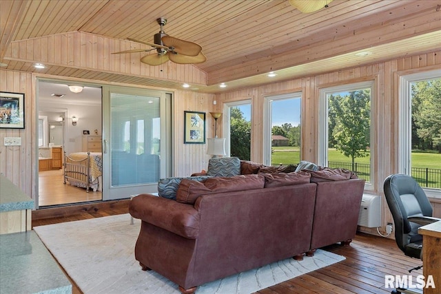 living room with hardwood / wood-style flooring, plenty of natural light, and lofted ceiling