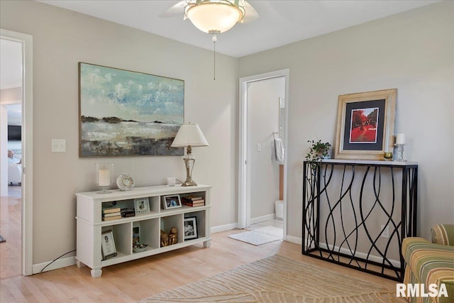 sitting room with ceiling fan and light hardwood / wood-style floors