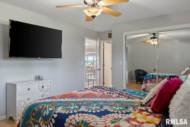 bedroom featuring ceiling fan, a closet, and wood-type flooring