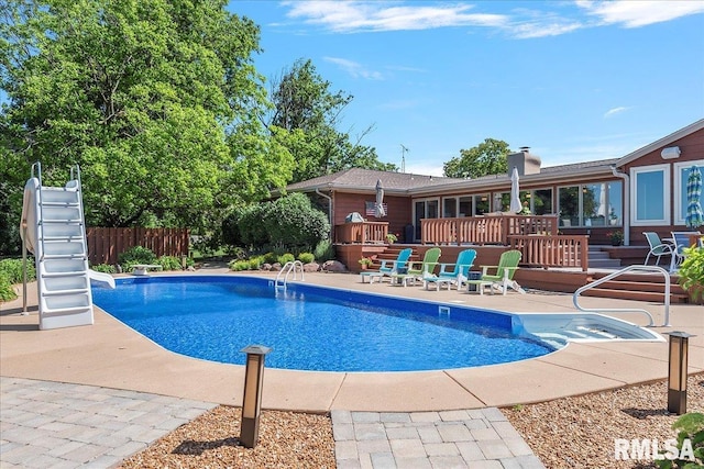 view of swimming pool with a patio area and a deck