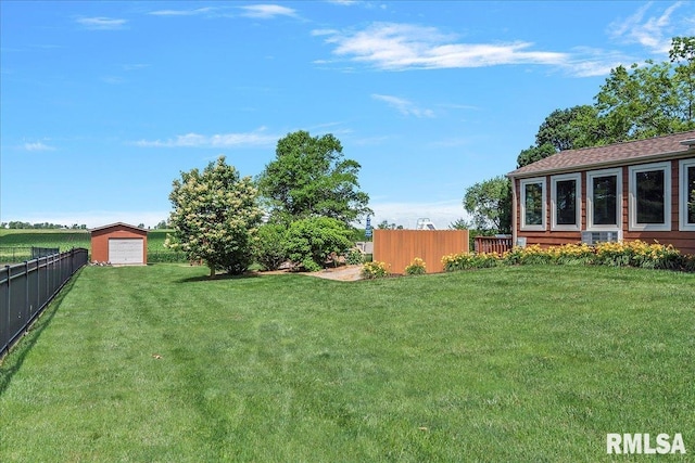 view of yard featuring a garage and an outdoor structure