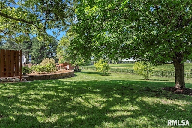 view of yard with a rural view