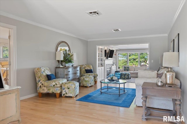 living room featuring light hardwood / wood-style floors and crown molding