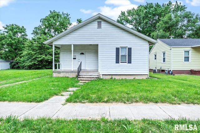 bungalow with a front yard and a porch