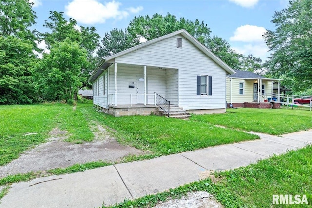 bungalow with a front yard and a porch