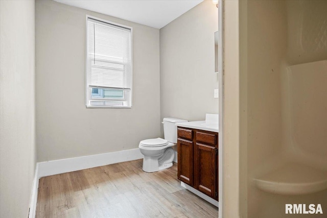 bathroom featuring hardwood / wood-style floors, vanity, and toilet