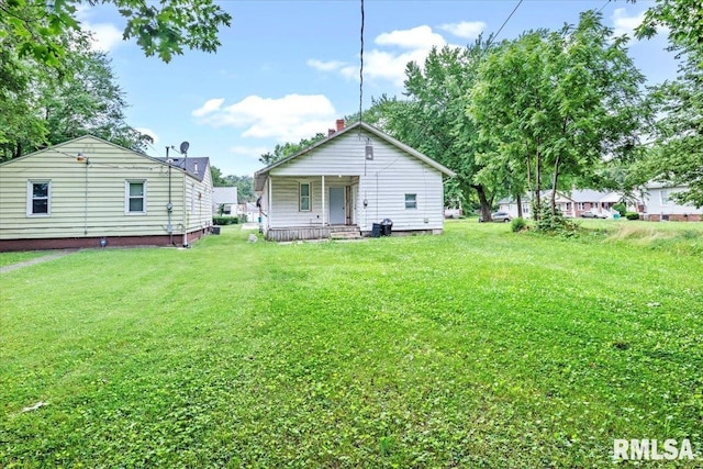 rear view of house with a lawn