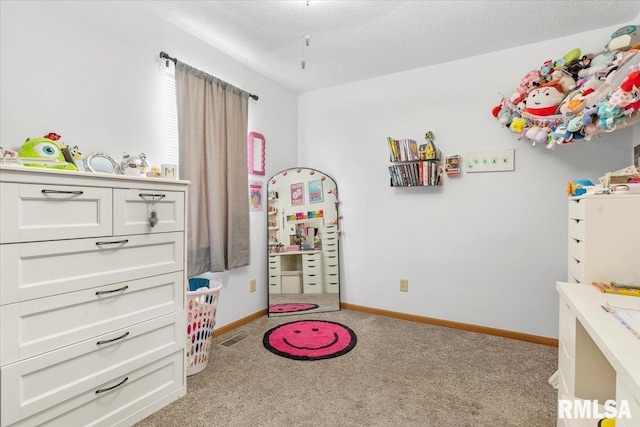 bedroom with light carpet and a textured ceiling