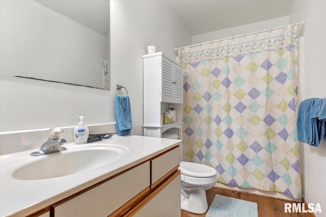 bathroom featuring curtained shower, vanity, hardwood / wood-style flooring, and toilet