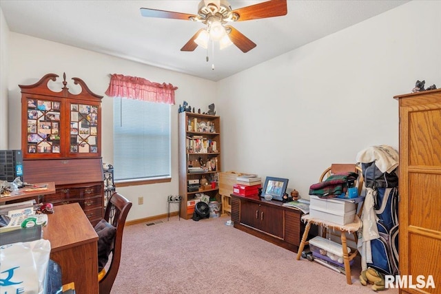 carpeted office space with ceiling fan