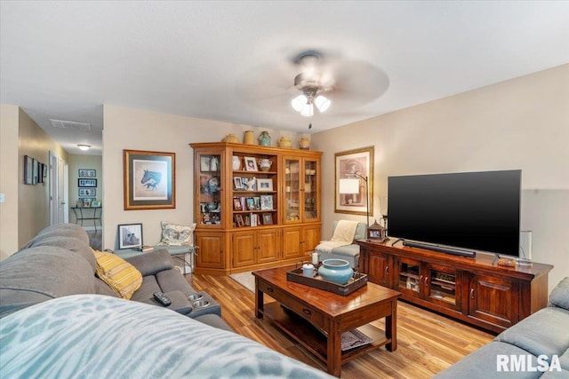 living room featuring ceiling fan and light hardwood / wood-style flooring