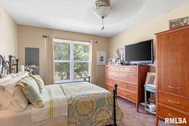 carpeted bedroom with electric panel, ceiling fan, and a textured ceiling