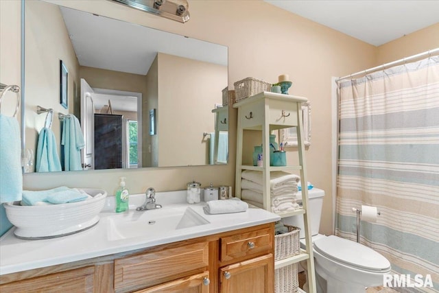 bathroom featuring vanity and toilet