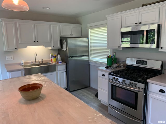 kitchen with white cabinetry, appliances with stainless steel finishes, and sink