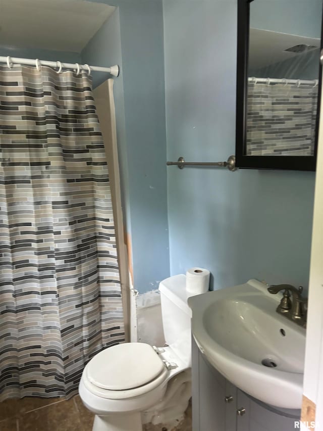 bathroom with a shower with curtain, vanity, tile patterned flooring, and toilet