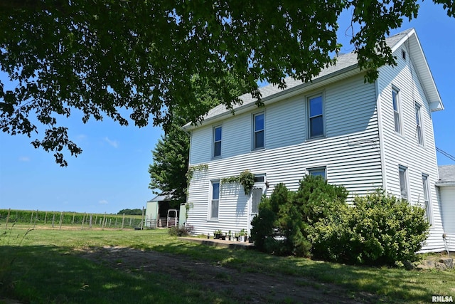 view of home's exterior with a yard