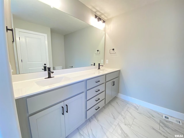 bathroom with vanity and toilet