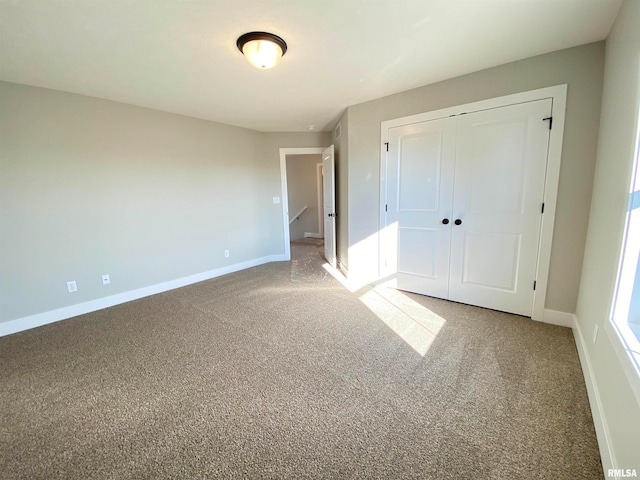 unfurnished bedroom with carpet flooring and a closet