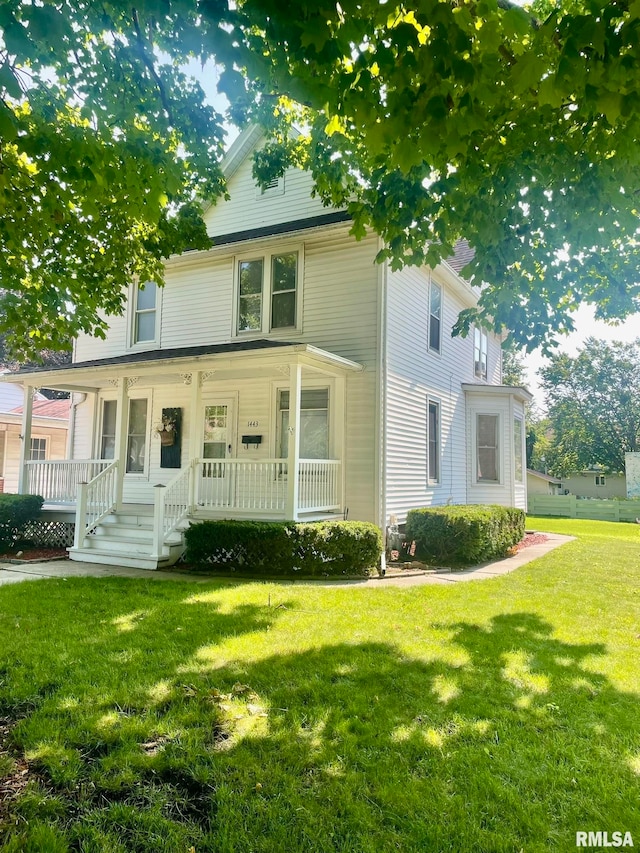 view of front of house with a porch and a front lawn