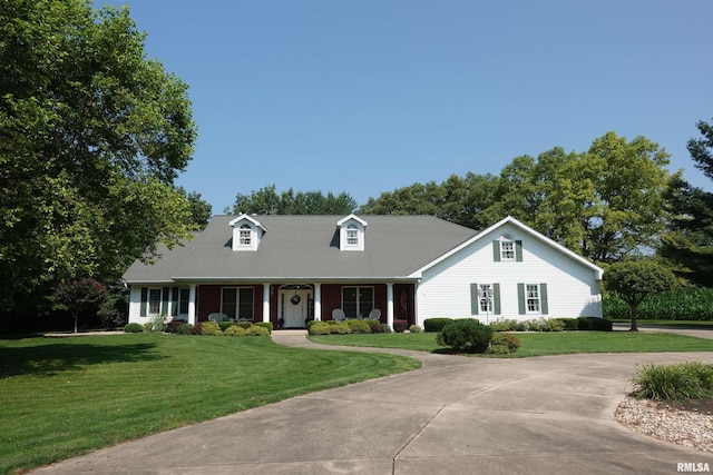 new england style home featuring a front yard