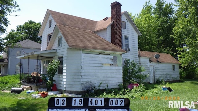 rear view of house with a yard