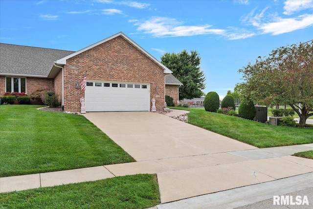 view of front of property with a garage and a front lawn