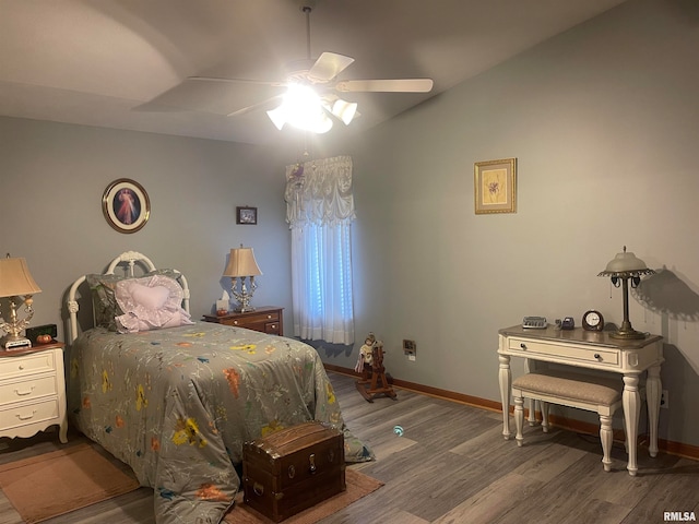 bedroom with dark hardwood / wood-style flooring and ceiling fan