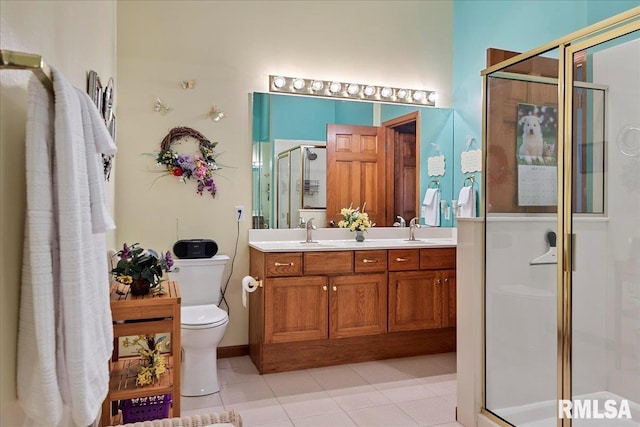 bathroom featuring toilet, an enclosed shower, vanity, and tile patterned floors