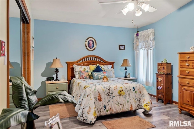 bedroom featuring a closet, light wood-type flooring, and ceiling fan