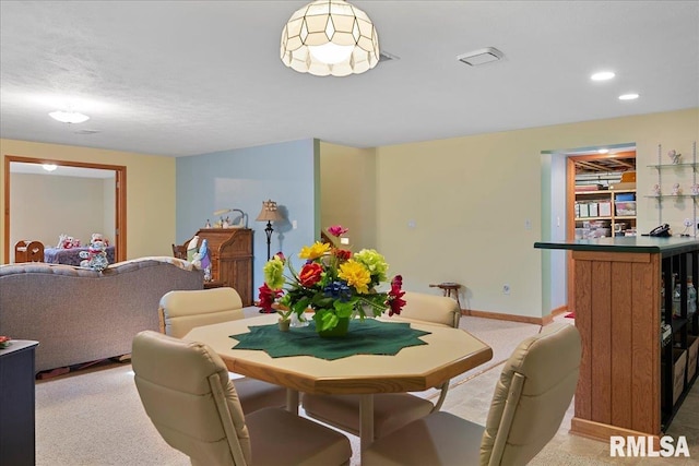 dining space with light carpet