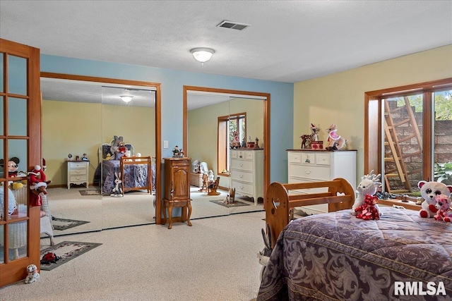 carpeted bedroom featuring a textured ceiling