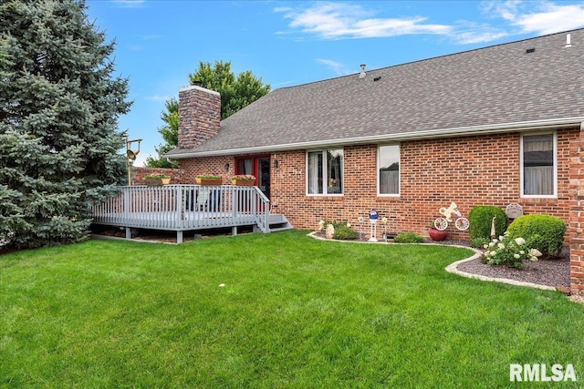 back of house with a wooden deck and a lawn