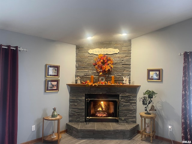 room details with a stone fireplace and hardwood / wood-style floors