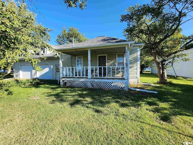 view of front facade featuring a garage, a front yard, and covered porch