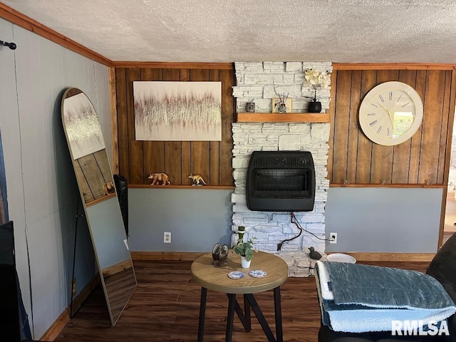 living room featuring a textured ceiling, wooden walls, and hardwood / wood-style floors