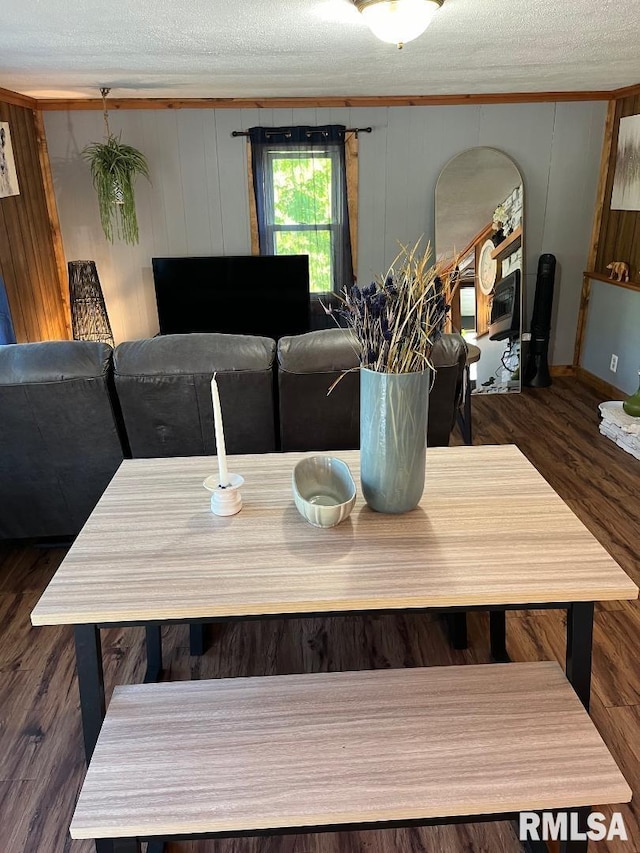 dining room with dark hardwood / wood-style floors and a textured ceiling