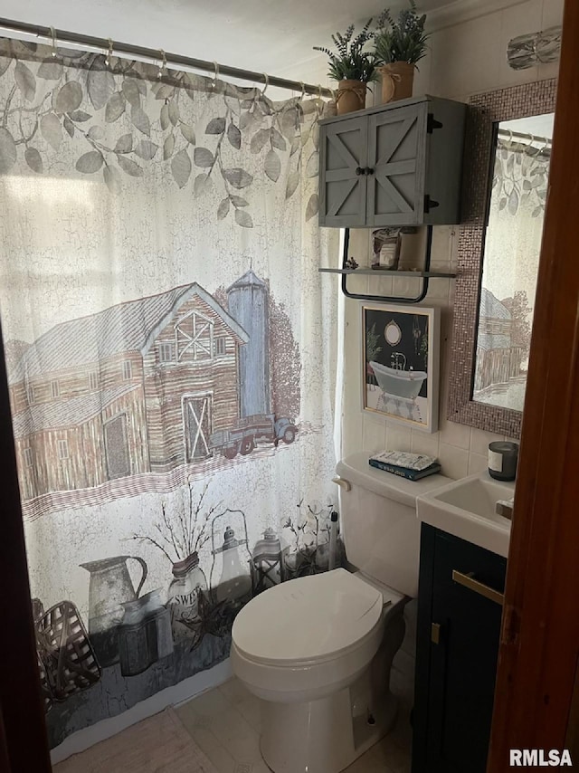 bathroom featuring vanity, toilet, and tile patterned flooring