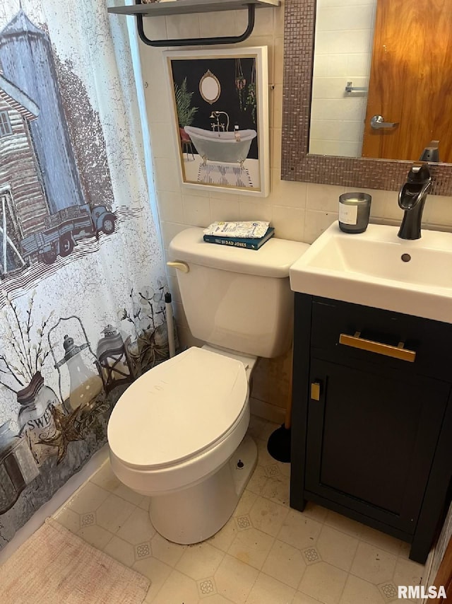 bathroom with tile patterned floors, vanity, and toilet